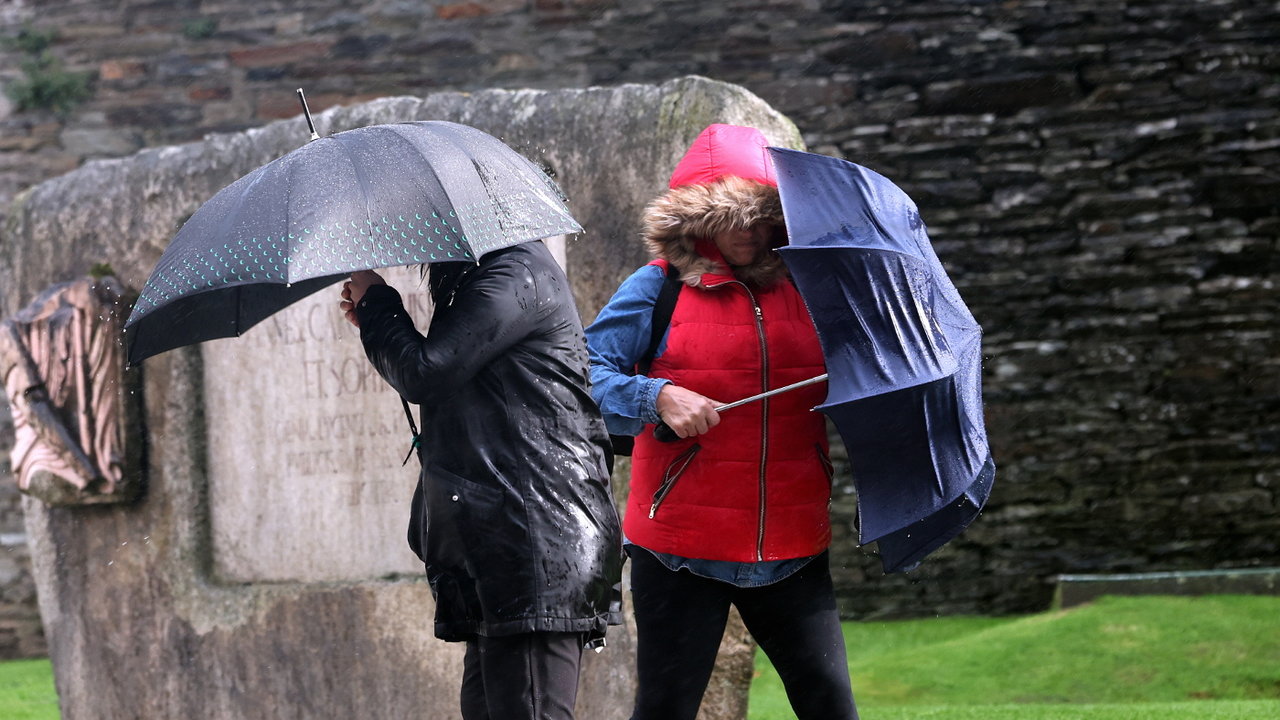 <p> Dos personas combaten la lluvia y el viento con sus paraguas. XESÚS PONTE </p>